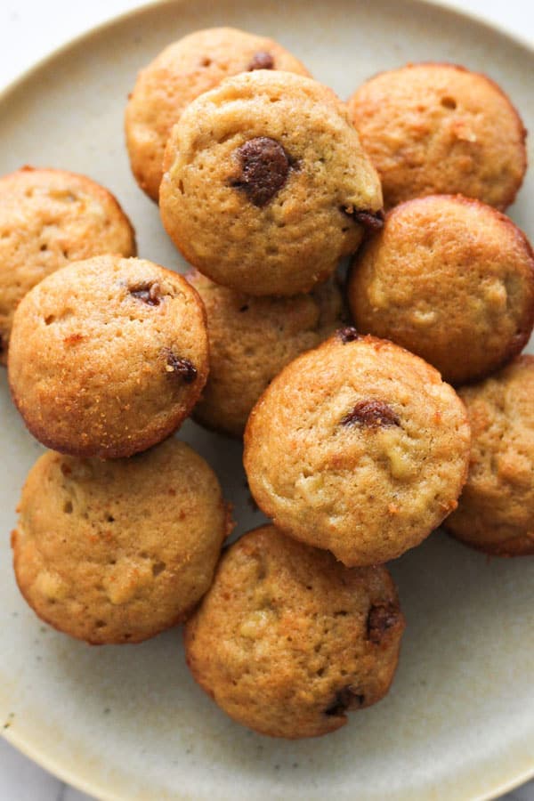 mini muffins stacked on a plate.