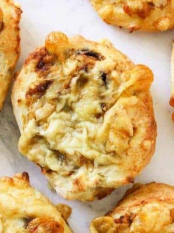 cheese and vegemite scrolls lying on a marble board.