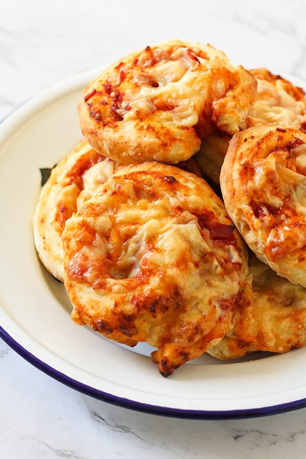 ham and cheese scrolls on a white plate.