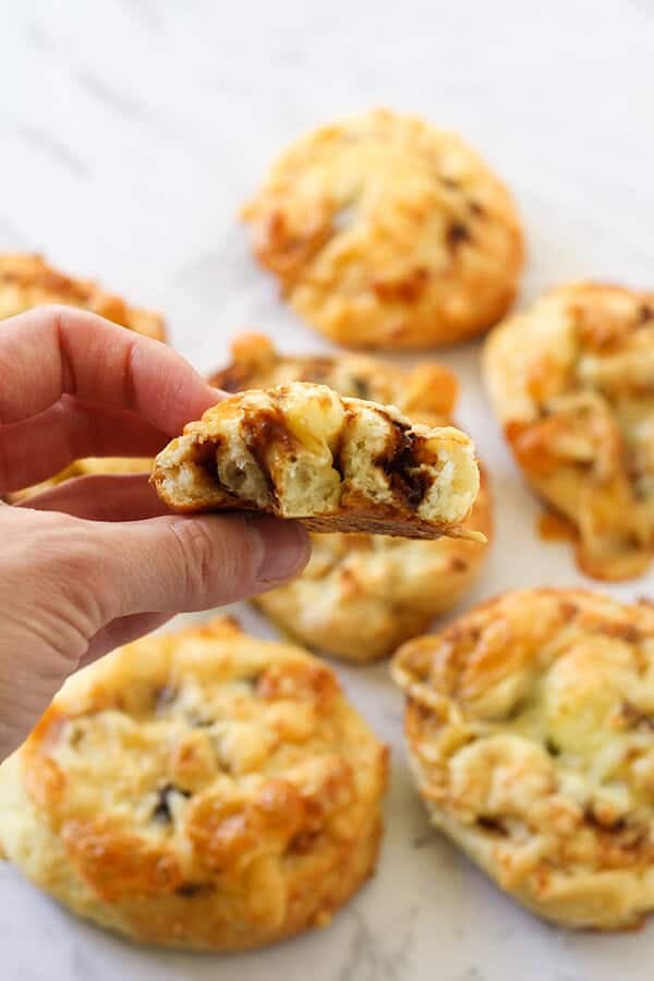 cheese and vegemite scrolls lying on a marble board.