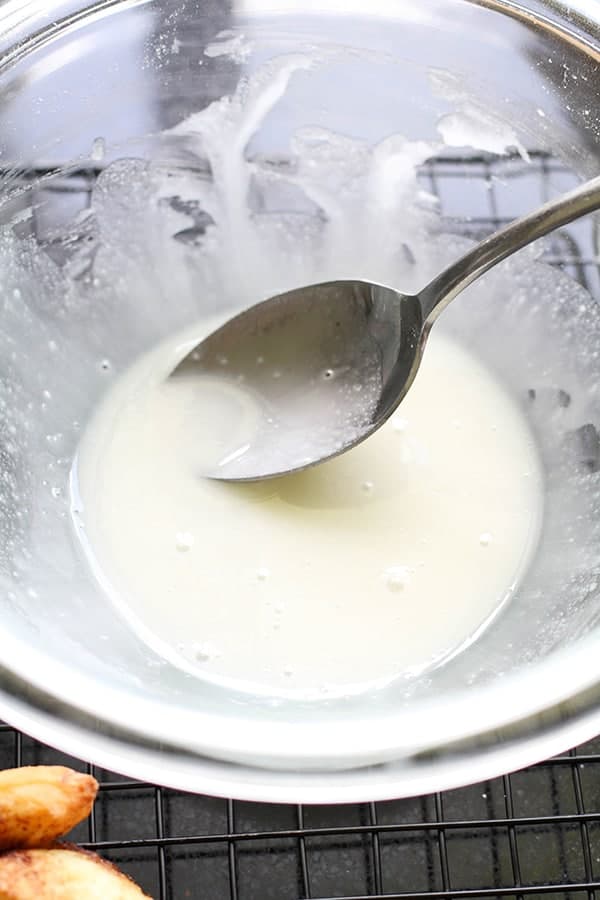 cinnamon roll glaze in a glass bowl.