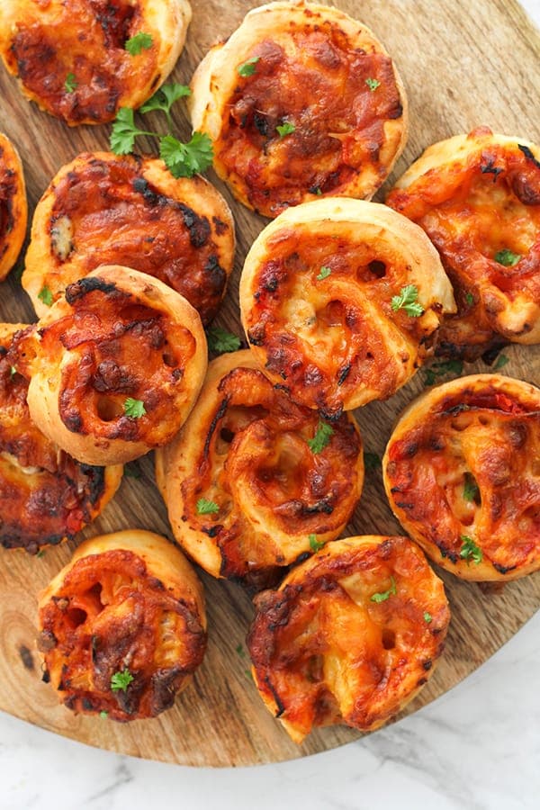 pizza scrolls on a wooden board.