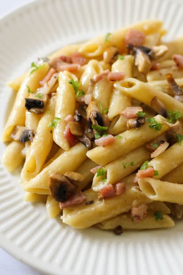 Creamy Carbonara on a white plate.