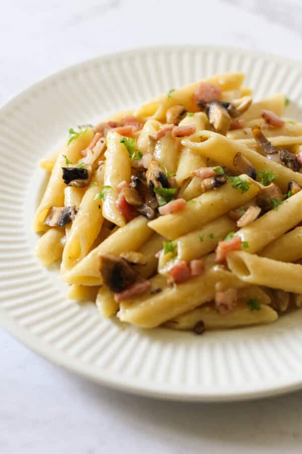 Creamy Carbonara on a white plate.
