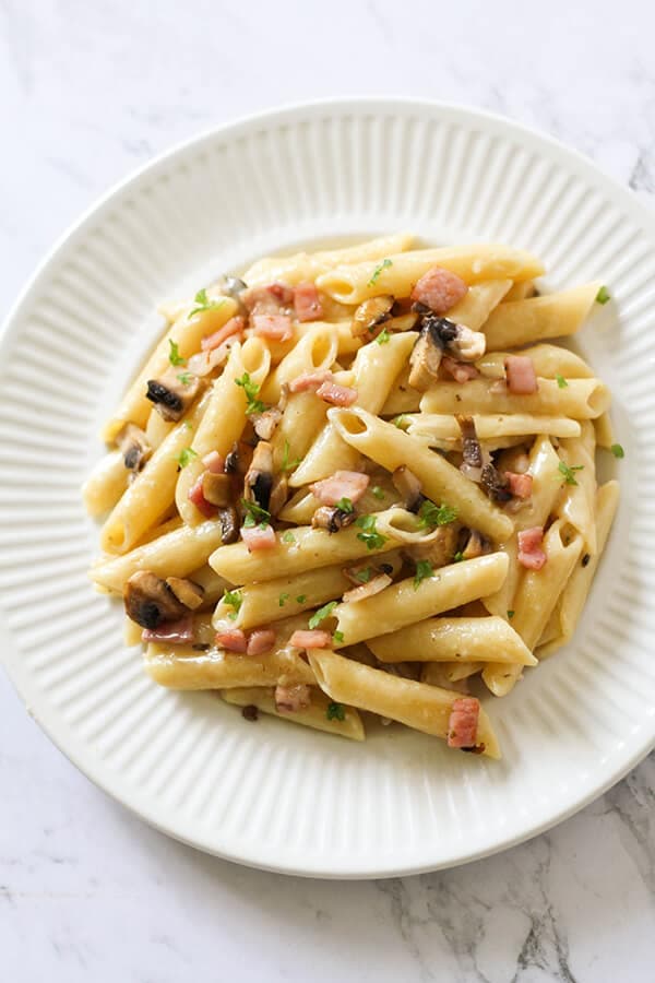 Creamy Carbonara on a white plate.