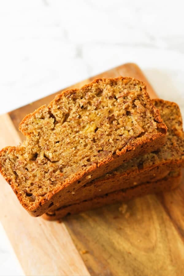 Sliced buttermilk banana bread laying on a wooden board.