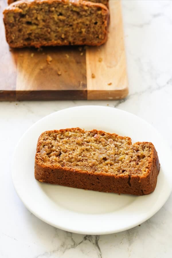 a slice of banana bread on a white plate.