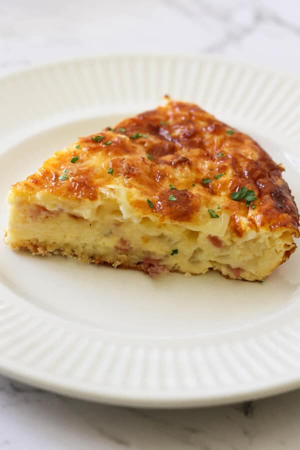 a slice of Impossible Quiche on a white plate.