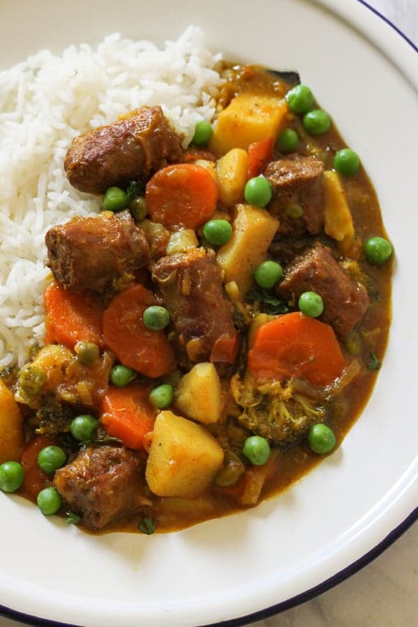 curried sausages on a bed of rice.