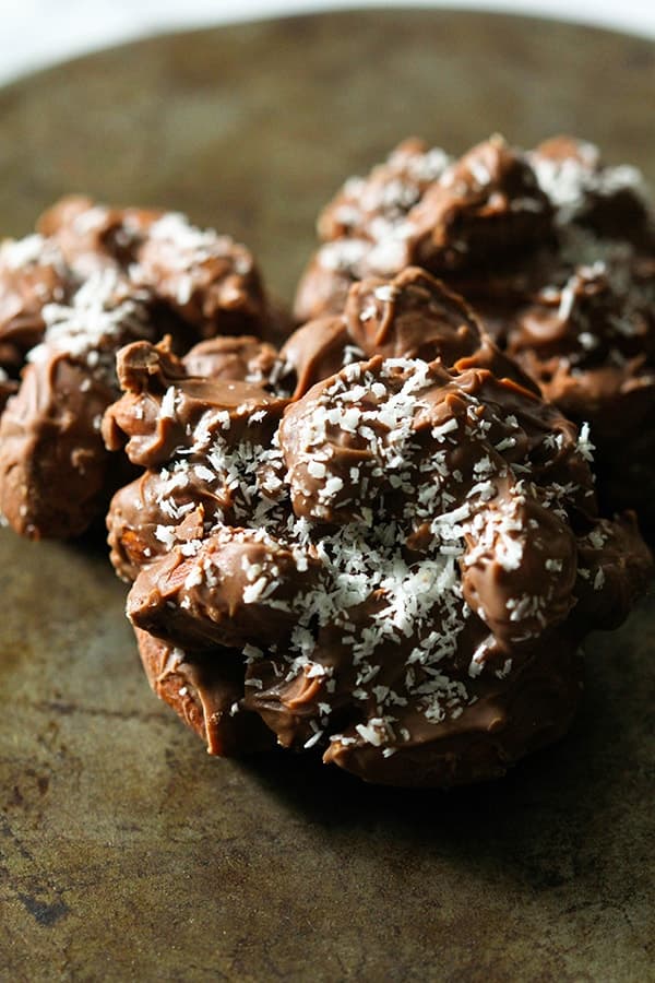 chocolate covered almonds on a rusted baking dish. 