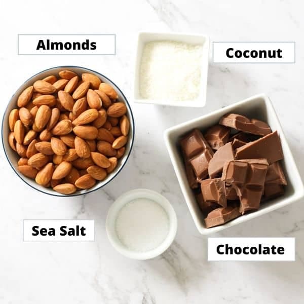 ingredients for chocolate covered almonds on a marble background.
