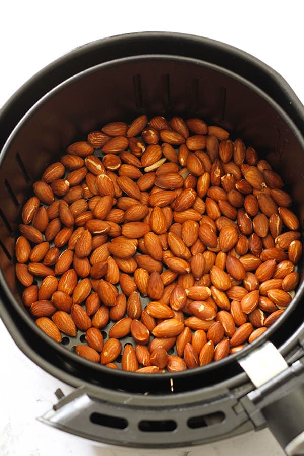 dry roasted almonds in air fryer basket.