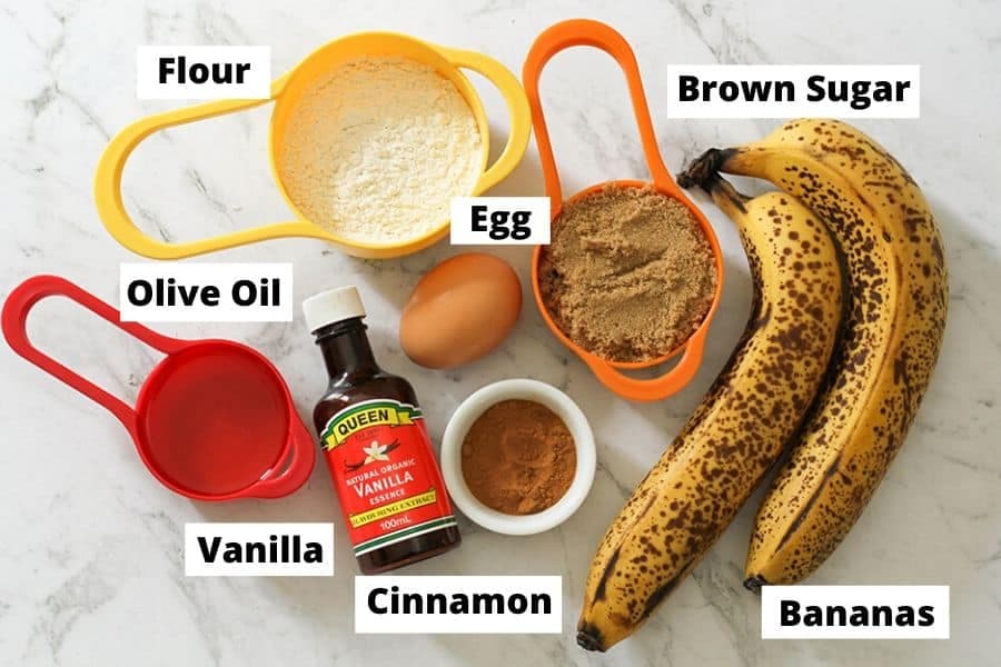 Air Fryer Banana Muffins Ingredients on a white marble background.
