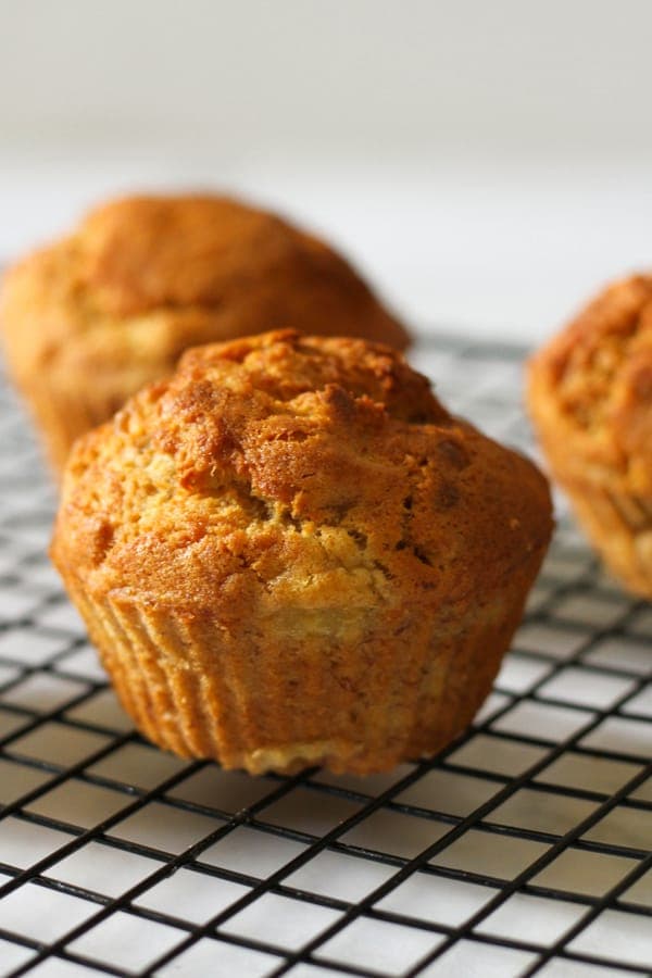 air fryer banana muffins on a wire cooling rack.