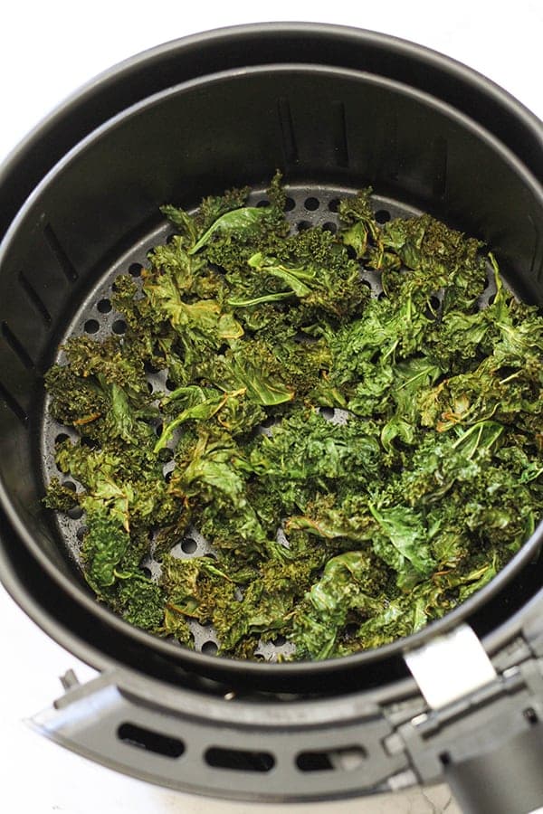 sweet & salty kales chips in an air fryer basket.