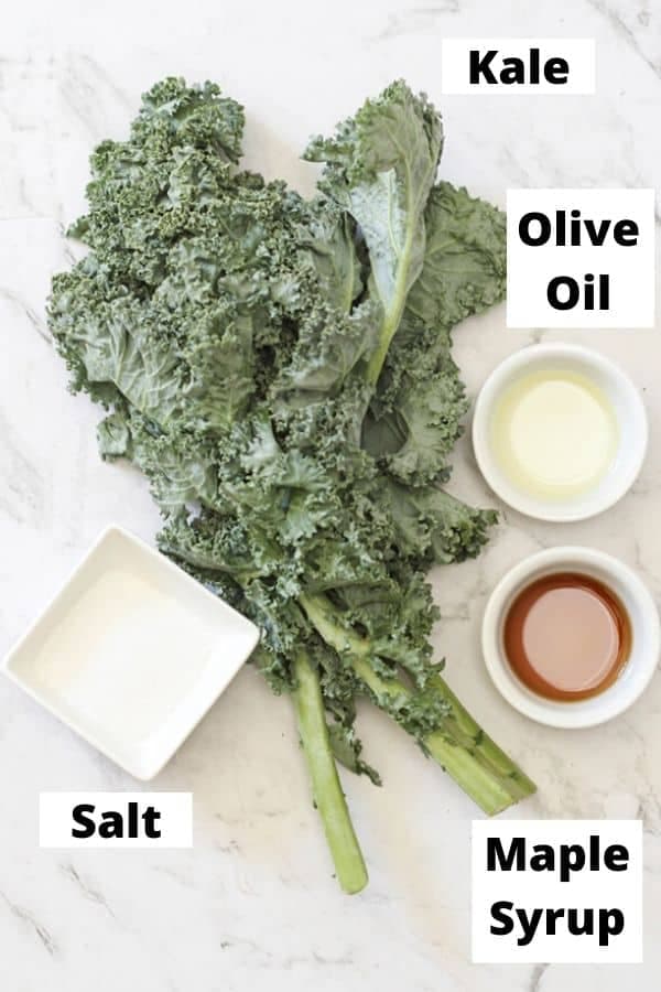 kale chips ingredients on a marble background.