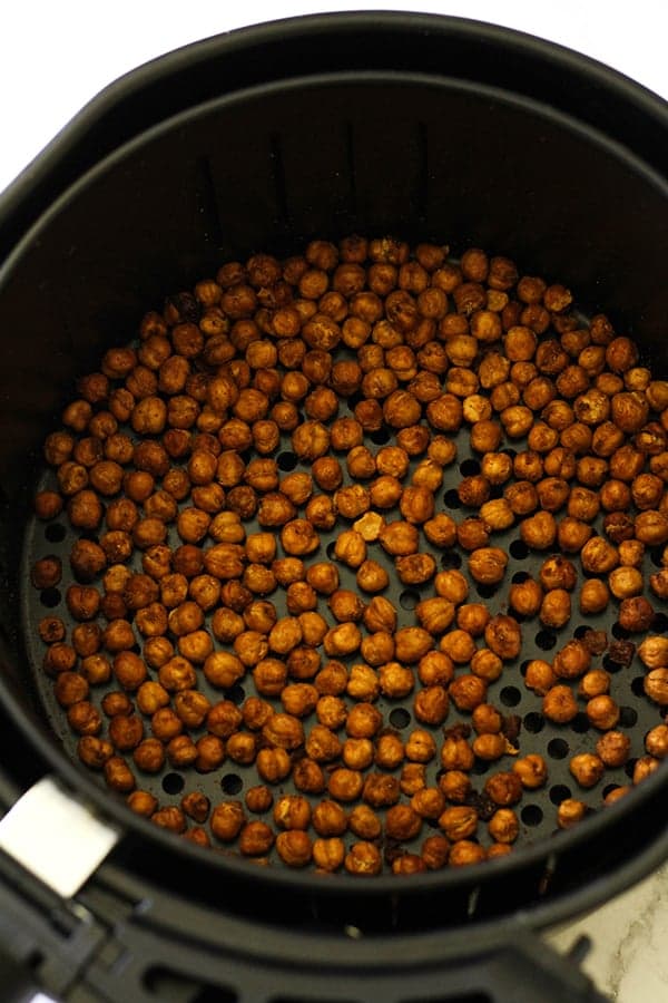 crispy chickpeas in an air fryer basket.