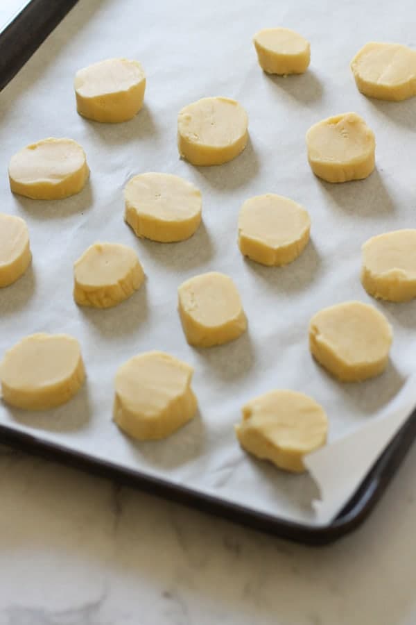 shortbread dough rounds on a baking tray.
