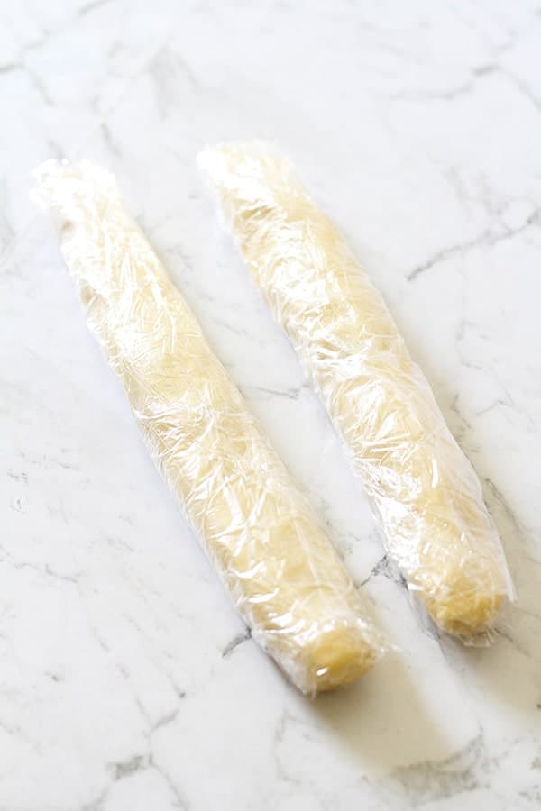 shortbread dough logs wrapped in plastic wrap.