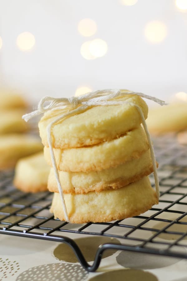 shortbread cookies stacked on top of a wire rack.