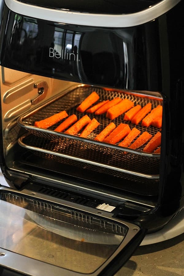 carrot sticks inside an air fryer.