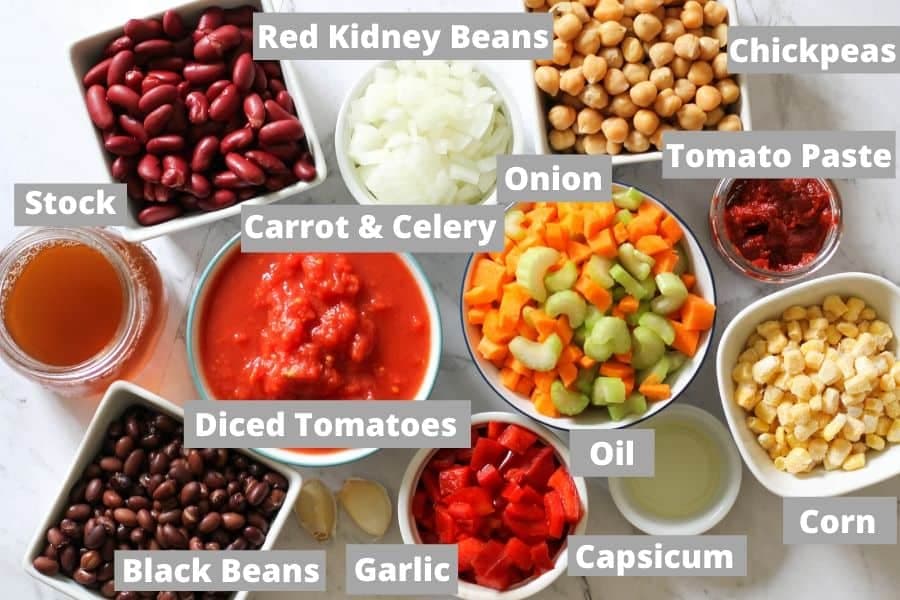 ingredients for vegetarian three bean chili on a white background.