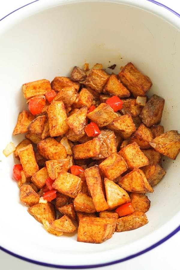 breakfast potatoes in a white bowl.