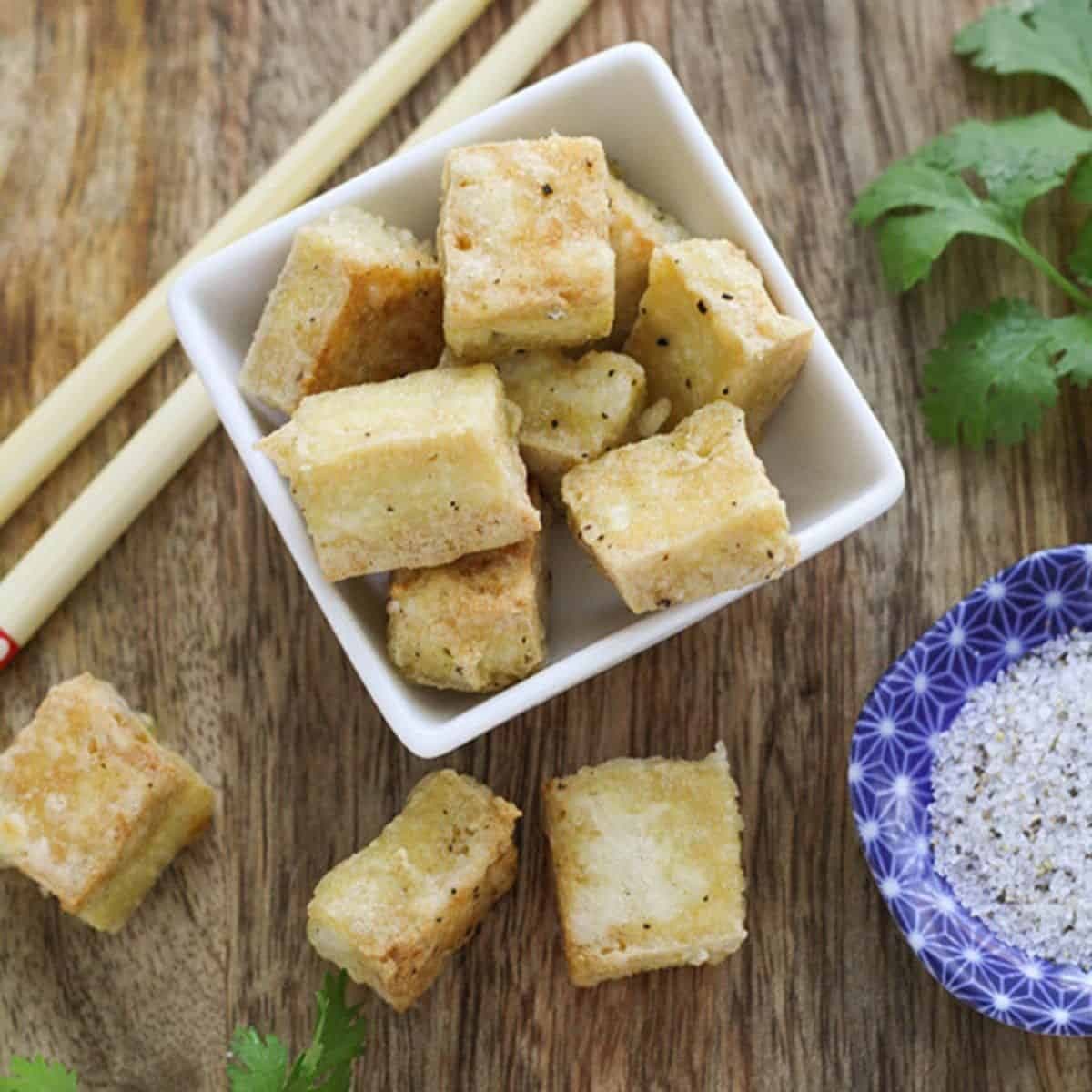 tofu bites in a square bowl.