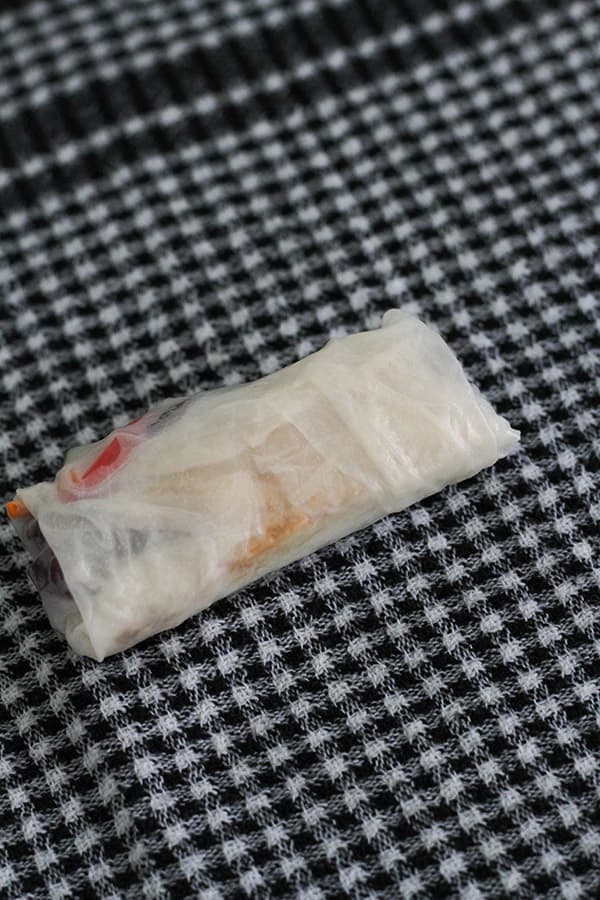 a rice paper roll on a kitchen towel.