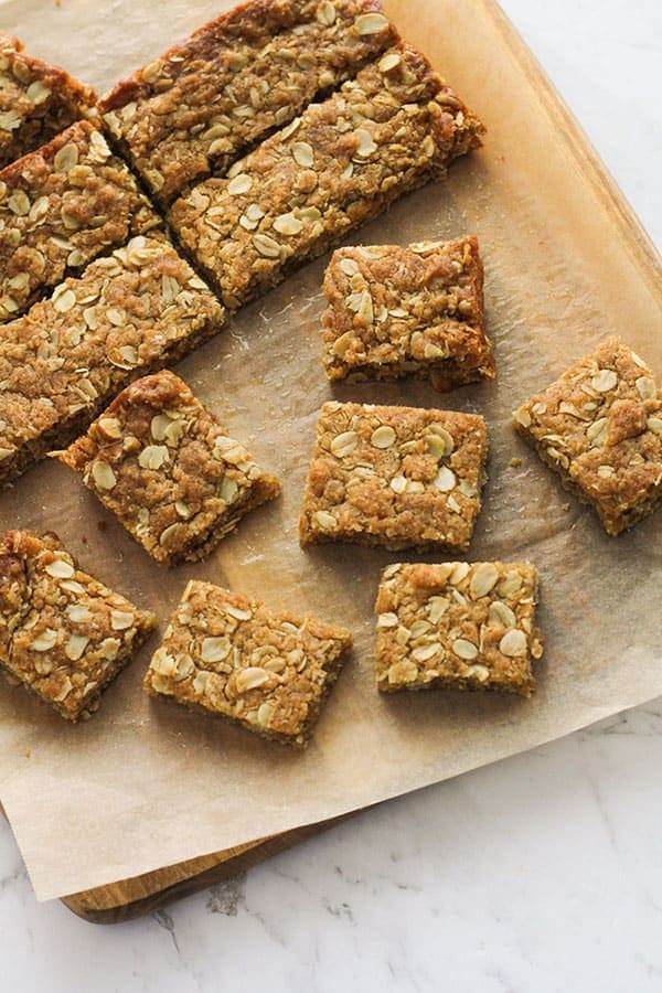anzac slice squares on a wooden board.