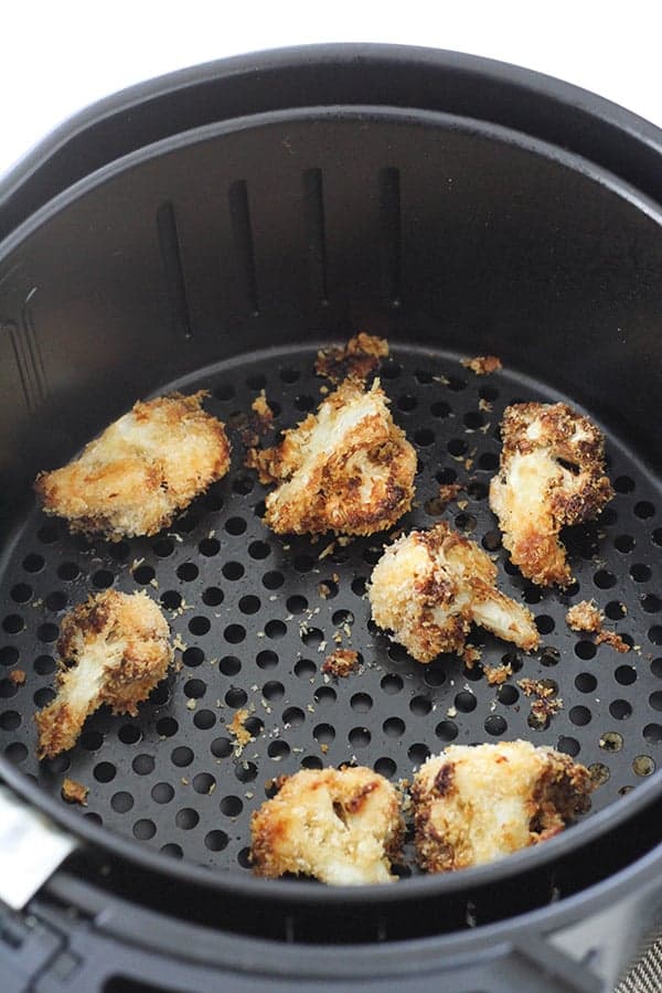 bang bang cauliflower in an air fryer basket.