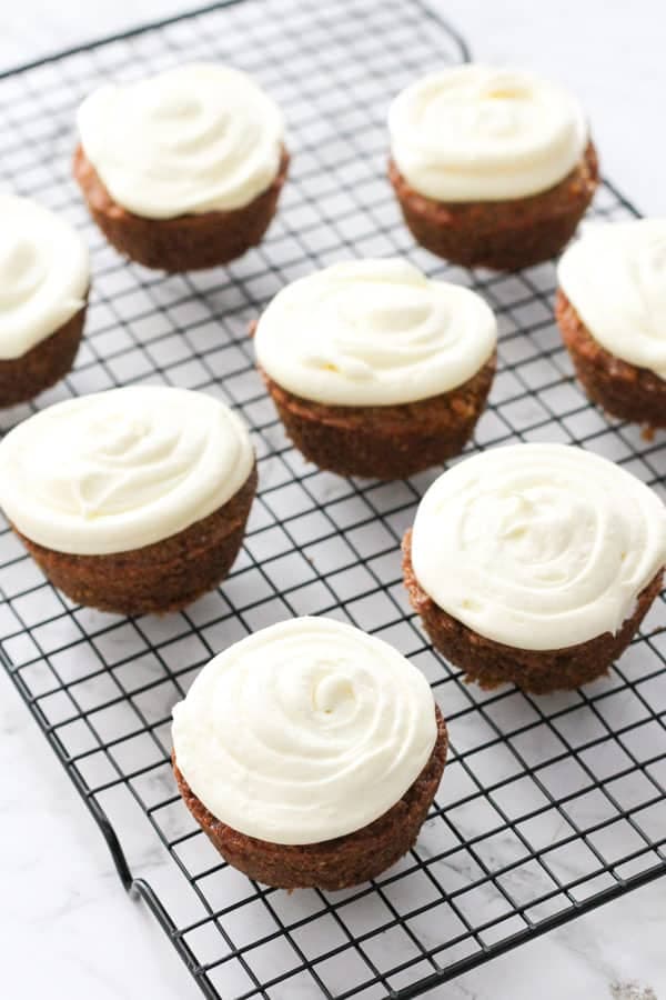 carrot cupcakes on a wire rack.