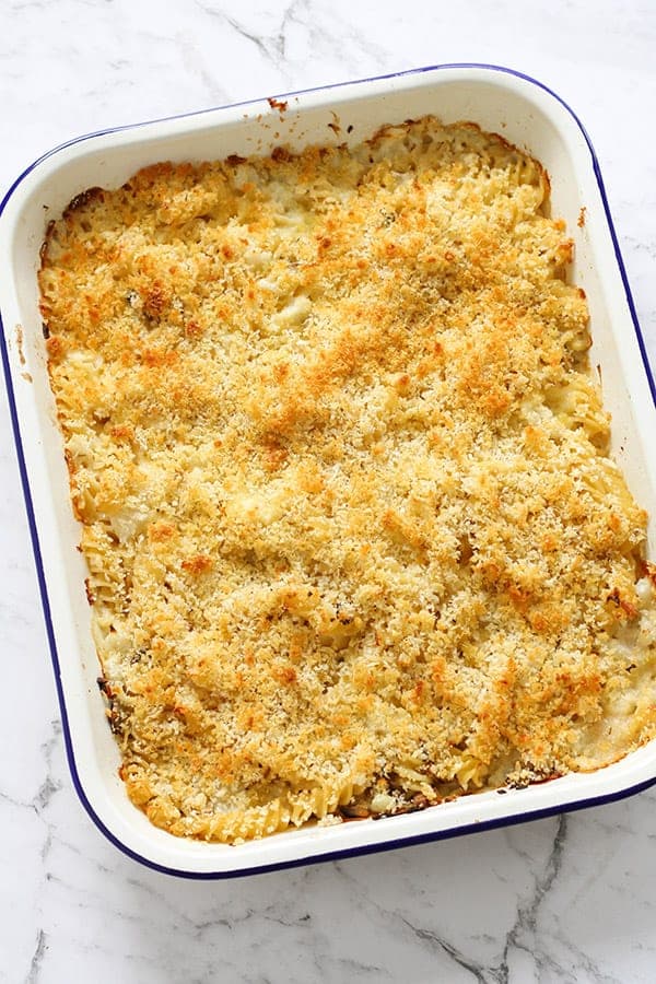 creamy vegetable pasta bake in a white baking dish.
