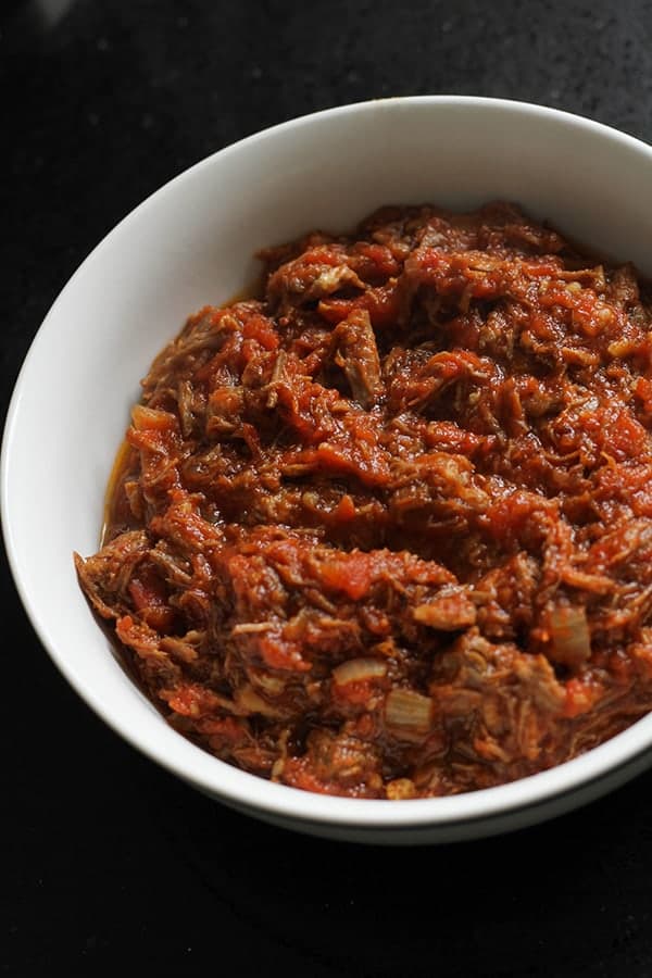 braised beef in a white bowl.