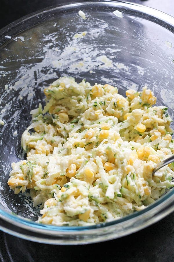fritter ingredients mixed together in a glass mixing bowl.