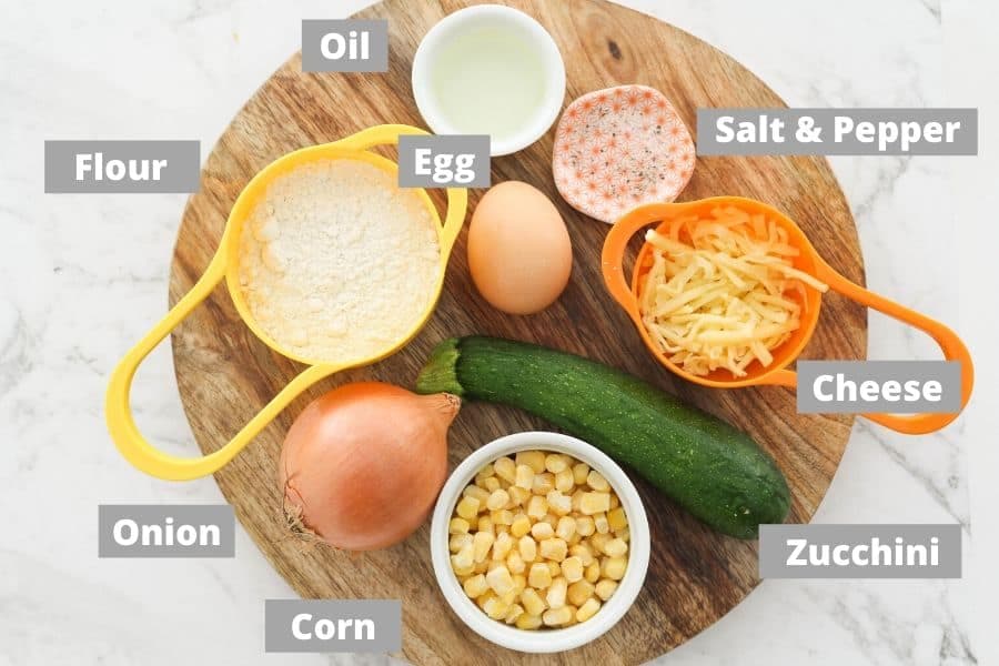 ingredients for fritters on a wooden platter.