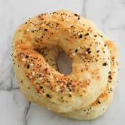 bagels stacked on top of each other on a marble board.