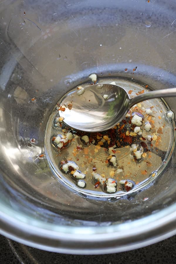 olive oil, minced garlic and chilli flakes in a glass bowl.