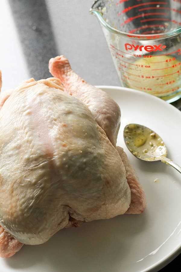 whole chicken on a white plate.