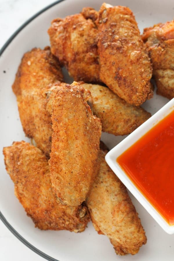 chicken wings on a white plate.