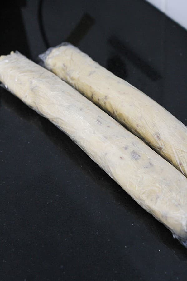 shortbread cookie dough rolled up in plastic wrap.