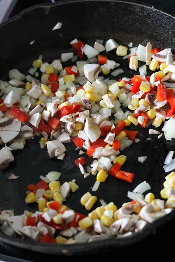 sautéed vegetables in a cast iron pan.
