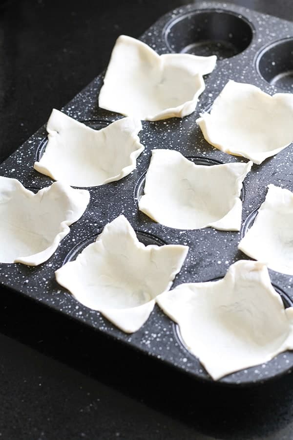 puff pastry squares divided into muffin cups.