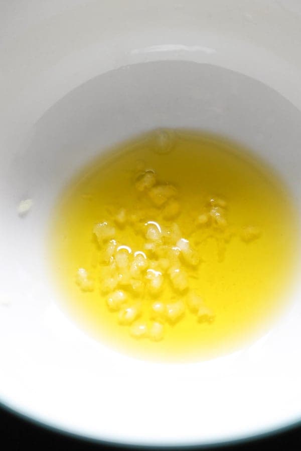 oil and minced garlic in a white bowl.