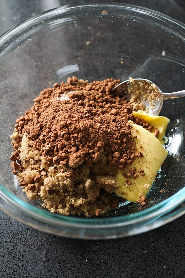 butter, sugar and cocoa powder in a glass bowl.