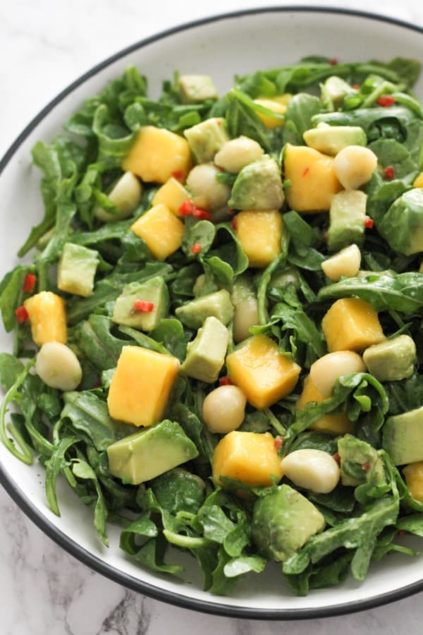 mango avocado salad in a white bowl.