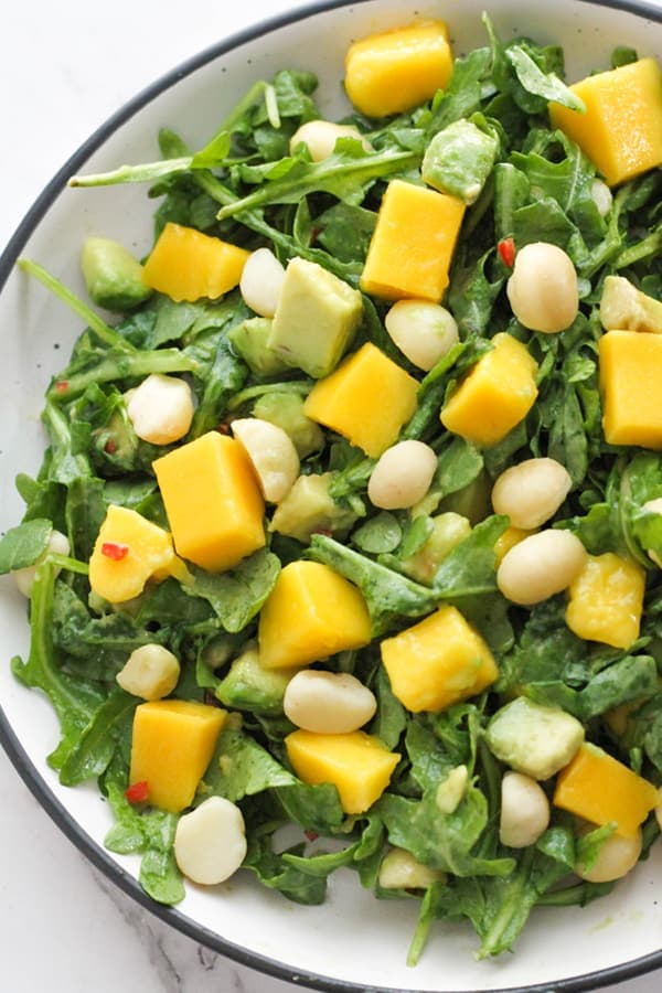 mango avocado salad in a white bowl.