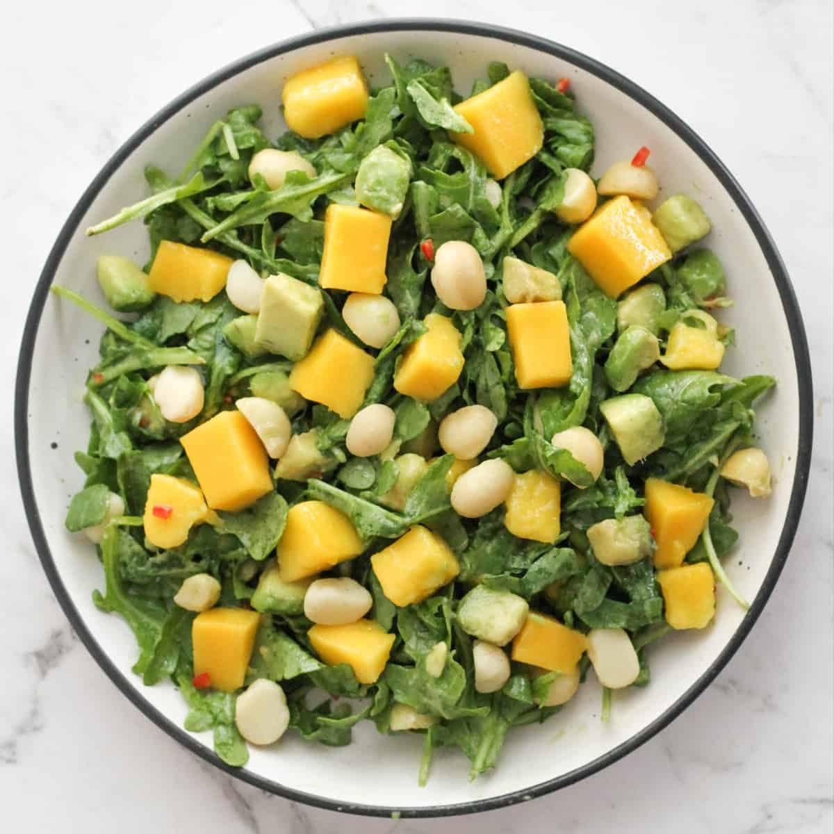 mango avocado salad in a white bowl.