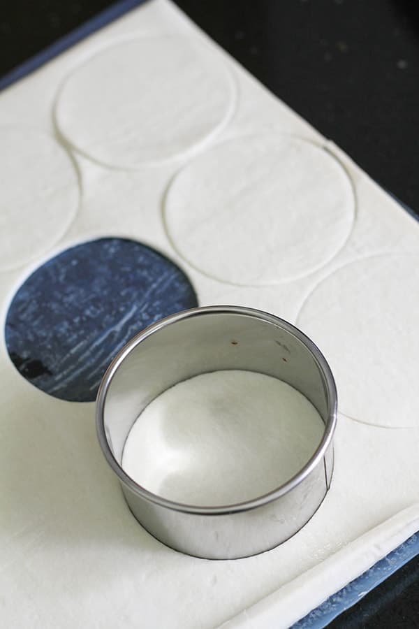 a pastry cutter sitting on top of a sheet of puff pastry.