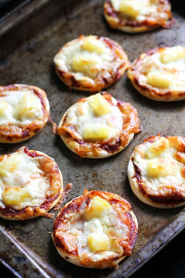 cooked mini pizza bites on a baking tray.